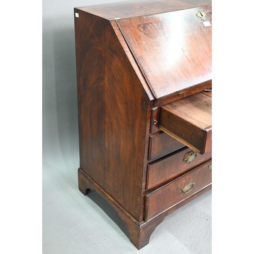 742 - An 18th century feather banded walnut bureau, the fitted interior centred by a cupboard over four lo... 