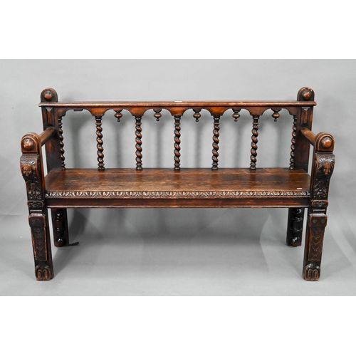 747 - A Victorian carved oak settle, the open back with five barley twist supports over flat arms, a plank... 