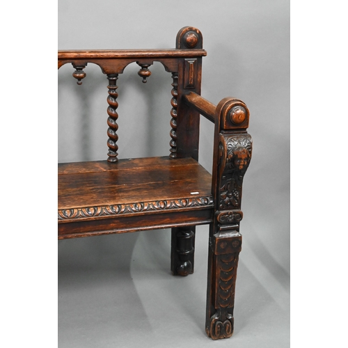747 - A Victorian carved oak settle, the open back with five barley twist supports over flat arms, a plank... 