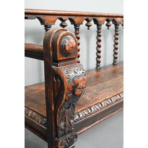 747 - A Victorian carved oak settle, the open back with five barley twist supports over flat arms, a plank... 