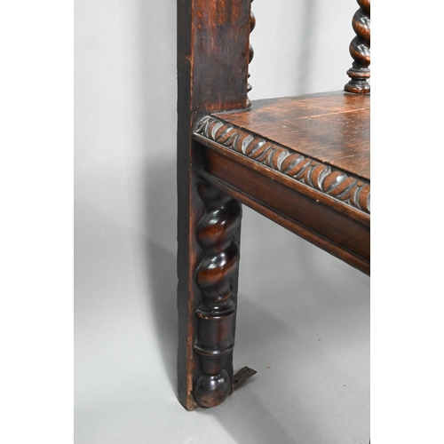 747 - A Victorian carved oak settle, the open back with five barley twist supports over flat arms, a plank... 