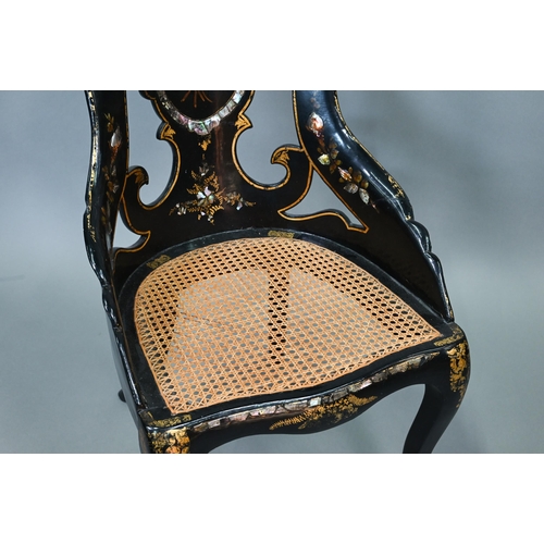 750 - Two Victorian black lacquered gilt and mother-of-pearl inlaid papier mache chairs, with caned seats,... 