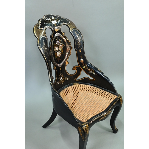 750 - Two Victorian black lacquered gilt and mother-of-pearl inlaid papier mache chairs, with caned seats,... 