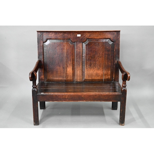 753 - A diminutive 18th century and later composed oak cottage settle, the twin panelled high back over sh... 