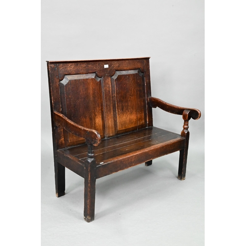 753 - A diminutive 18th century and later composed oak cottage settle, the twin panelled high back over sh... 