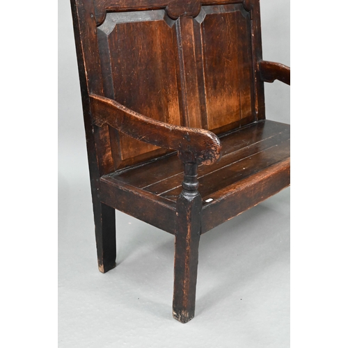 753 - A diminutive 18th century and later composed oak cottage settle, the twin panelled high back over sh... 