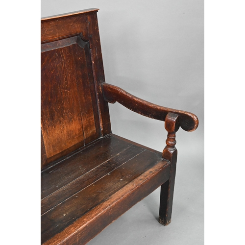 753 - A diminutive 18th century and later composed oak cottage settle, the twin panelled high back over sh... 