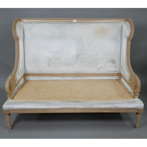 754 - A French Empire style two seater sofa, the carved and moulded frame washed off-white, having a fabri... 