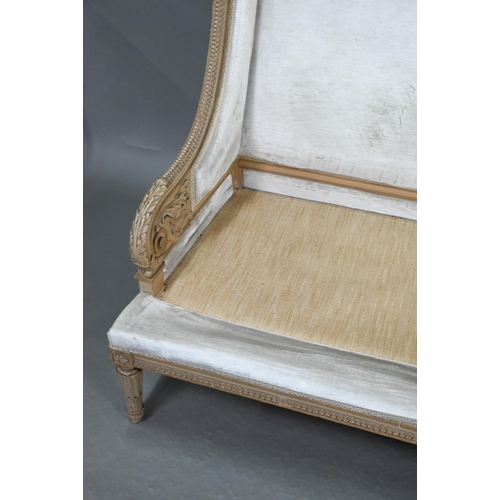 754 - A French Empire style two seater sofa, the carved and moulded frame washed off-white, having a fabri... 