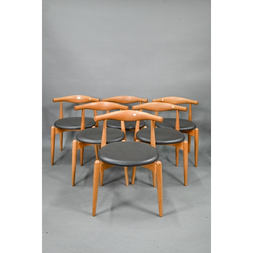 A set of six Danish CH20 oak framed chairs by Carl Hanson & Son, designed by Hans J Wegner, with brown leather seats, each chair numbered and labelled (6)