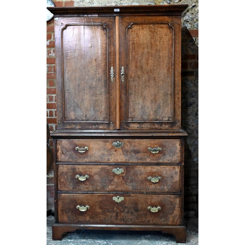 758 - An 18th century and later walnut two part cabinet on chest, the moulded cornice over a pair of mould... 