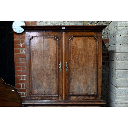 758 - An 18th century and later walnut two part cabinet on chest, the moulded cornice over a pair of mould... 