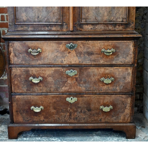 758 - An 18th century and later walnut two part cabinet on chest, the moulded cornice over a pair of mould... 