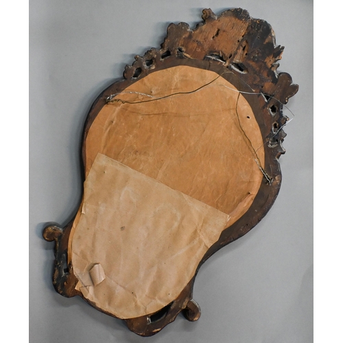 760 - An antique carved giltwood framed cartel form mirror, 52 cm x 32 cm h