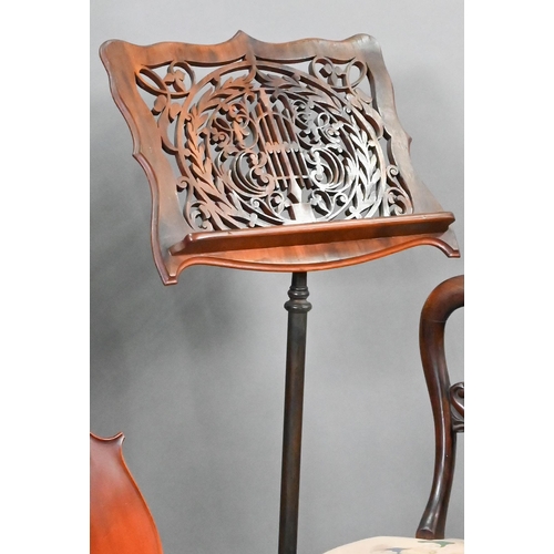 763 - A Victorian fret cut adjustable easel music stand, raised on a rise and fall pole and cast iron base