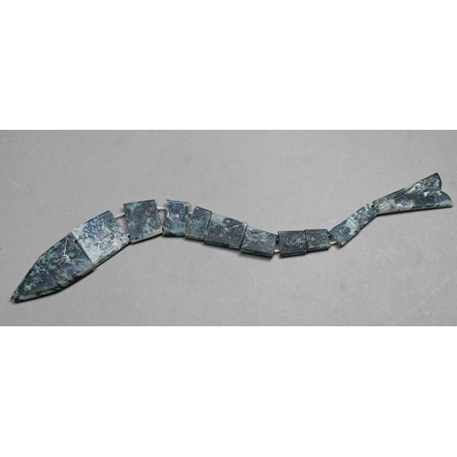 902 - A carved soapstone articulated fish with incised roundel decoration, 27 cm