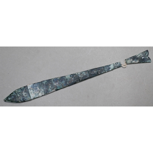 902 - A carved soapstone articulated fish with incised roundel decoration, 27 cm