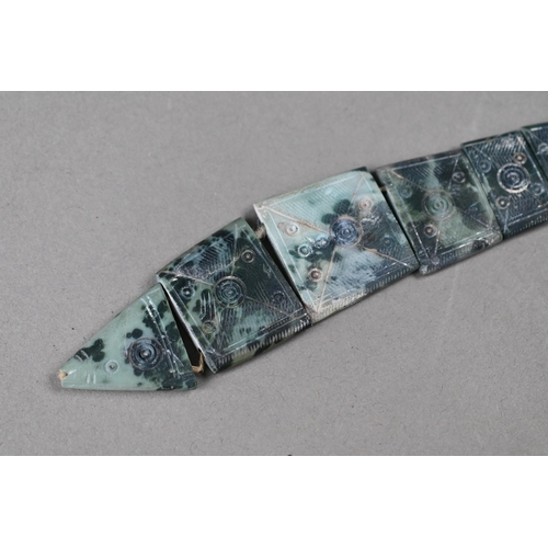 902 - A carved soapstone articulated fish with incised roundel decoration, 27 cm