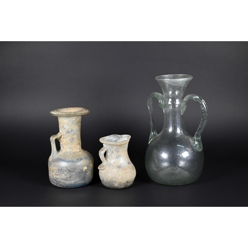 906 - Two Mediterranean antiquity glass jugs, 12/8 cm to/w a similar, later jar (3)