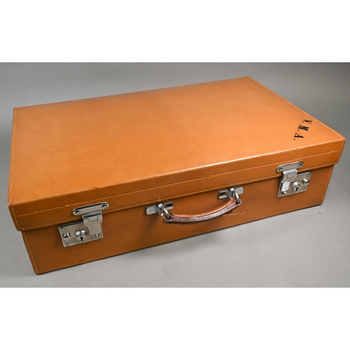 919 - A 1930s pigskin suitcase with fittings including six silver-topped glass jars and bottles, London 19... 