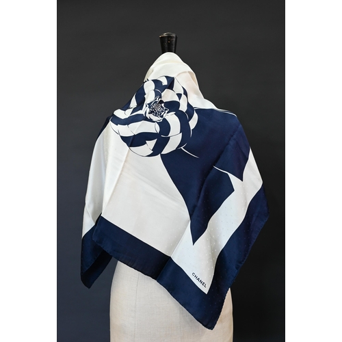 920 - Chanel - A navy and cream silk scarf featuring camellia ribbon pattern, rolled edge, 87 x 87 cmSome ... 