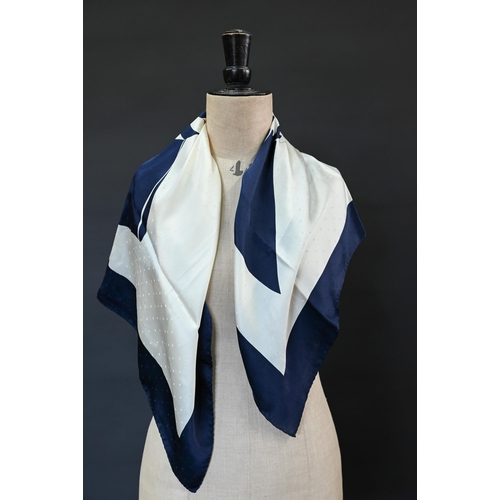 920 - Chanel - A navy and cream silk scarf featuring camellia ribbon pattern, rolled edge, 87 x 87 cmSome ... 