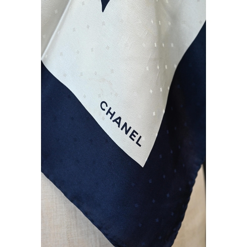 920 - Chanel - A navy and cream silk scarf featuring camellia ribbon pattern, rolled edge, 87 x 87 cmSome ... 