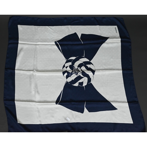 920 - Chanel - A navy and cream silk scarf featuring camellia ribbon pattern, rolled edge, 87 x 87 cmSome ... 