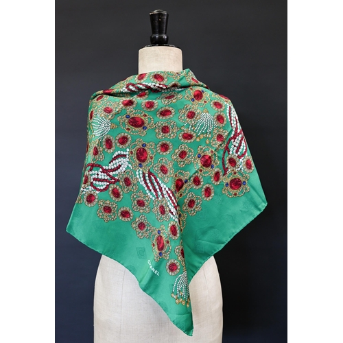 921 - Chanel - A silk scarf featuring jewels on emerald green ground, rolled edge, 87 x 87 cmSome very fai... 