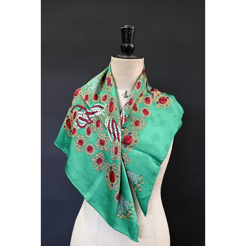 921 - Chanel - A silk scarf featuring jewels on emerald green ground, rolled edge, 87 x 87 cmSome very fai... 