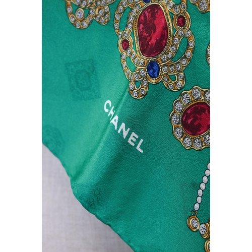 921 - Chanel - A silk scarf featuring jewels on emerald green ground, rolled edge, 87 x 87 cmSome very fai... 