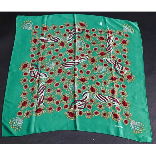 921 - Chanel - A silk scarf featuring jewels on emerald green ground, rolled edge, 87 x 87 cmSome very fai... 