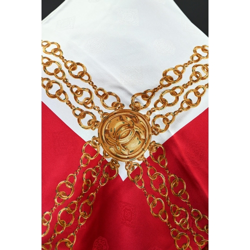 922 - Chanel - A red and cream silk scarf featuring gold chains, rolled edge, 87 x 87 cmGood condition... 