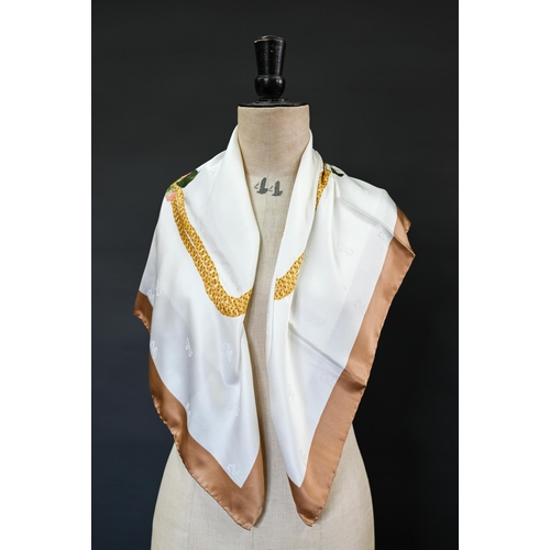 924 - Chanel - A cream and beige silk scarf featuring camellia garlands and gold chains, rolled edge, 87 x... 