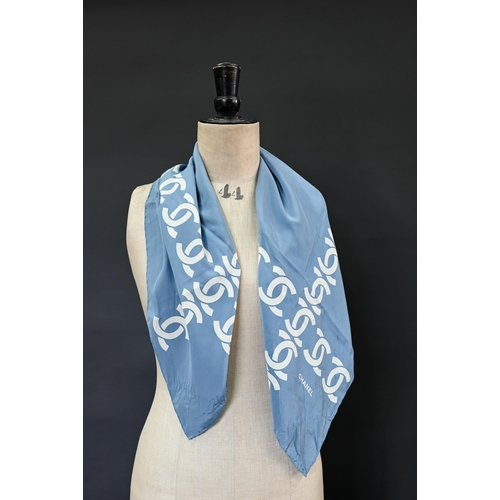 925 - Chanel - A blue silk scarf featuring Chanel logo in cream, rolled edge, 87 x 87 cm Some faint marks ... 