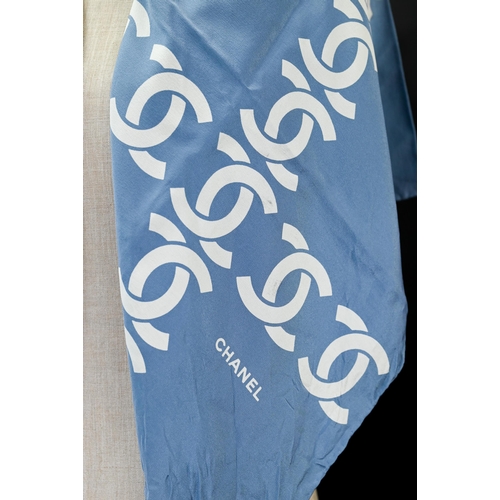 925 - Chanel - A blue silk scarf featuring Chanel logo in cream, rolled edge, 87 x 87 cm Some faint marks ... 