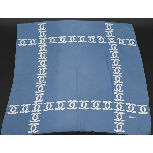 925 - Chanel - A blue silk scarf featuring Chanel logo in cream, rolled edge, 87 x 87 cm Some faint marks ... 