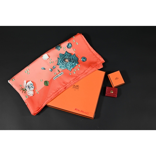 930 - Hermés - A boxed silk scarf featuring pink flowers, rolled edge, 87 x 87 cm to/w a Hermés crimson le... 