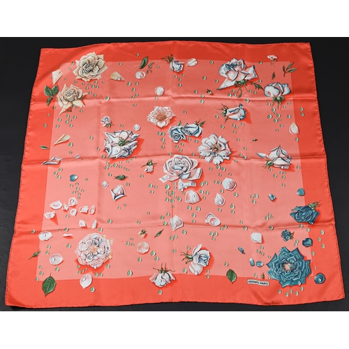 930 - Hermés - A boxed silk scarf featuring pink flowers, rolled edge, 87 x 87 cm to/w a Hermés crimson le... 