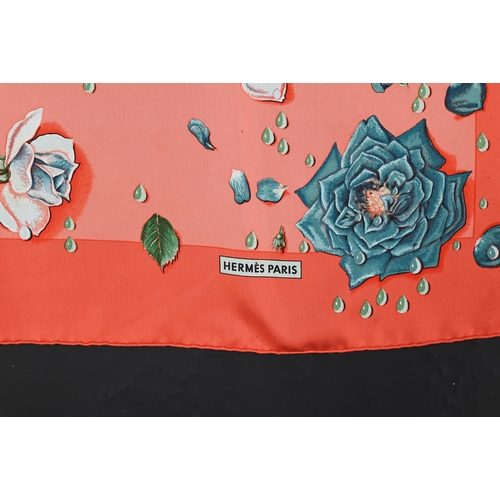 930 - Hermés - A boxed silk scarf featuring pink flowers, rolled edge, 87 x 87 cm to/w a Hermés crimson le... 