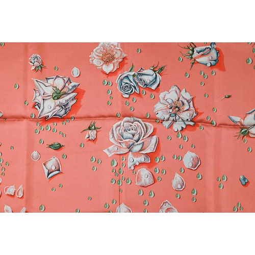 930 - Hermés - A boxed silk scarf featuring pink flowers, rolled edge, 87 x 87 cm to/w a Hermés crimson le... 