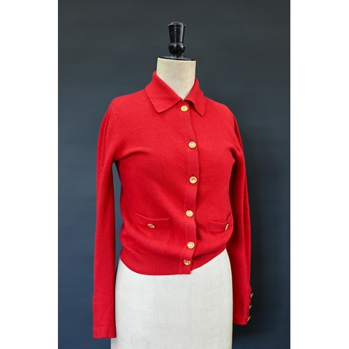 931 - Chanel - A red cashmere cardigan with collar and two pockets, gilt metal Chanel buttons to cuffs, po... 