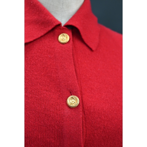 931 - Chanel - A red cashmere cardigan with collar and two pockets, gilt metal Chanel buttons to cuffs, po... 