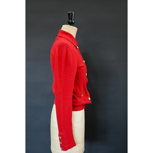 931 - Chanel - A red cashmere cardigan with collar and two pockets, gilt metal Chanel buttons to cuffs, po... 