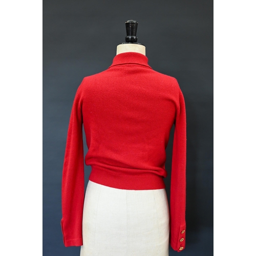 931 - Chanel - A red cashmere cardigan with collar and two pockets, gilt metal Chanel buttons to cuffs, po... 