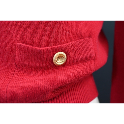 931 - Chanel - A red cashmere cardigan with collar and two pockets, gilt metal Chanel buttons to cuffs, po... 