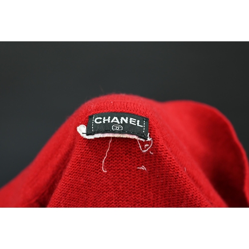 931 - Chanel - A red cashmere cardigan with collar and two pockets, gilt metal Chanel buttons to cuffs, po... 