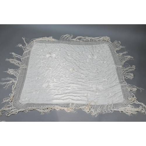 937 - A cream silk piano shawl embroidered with flowers and butterflies with deep silk fringing, 110 cm sq... 