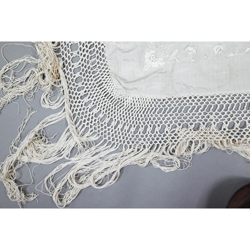 937 - A cream silk piano shawl embroidered with flowers and butterflies with deep silk fringing, 110 cm sq... 