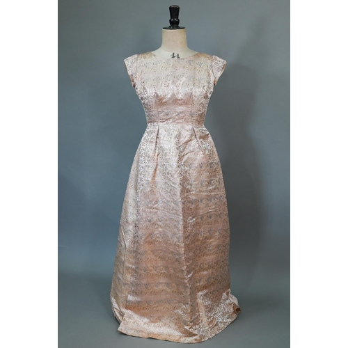 938 - A 1950s pink and gold Chinese brocade evening gown by Caley's of Windsor; a cream and gold gauze dre... 